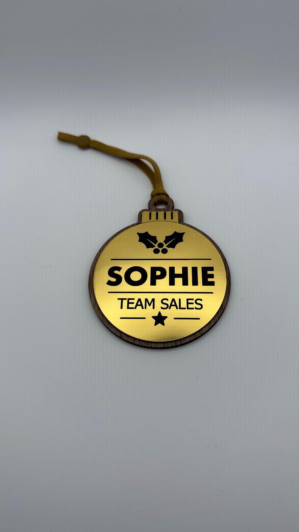 Gold personalised Christmas bauble Design 1, actual product photograph; standard design example, customer wording replaces example text. Hanging strip colour varies.