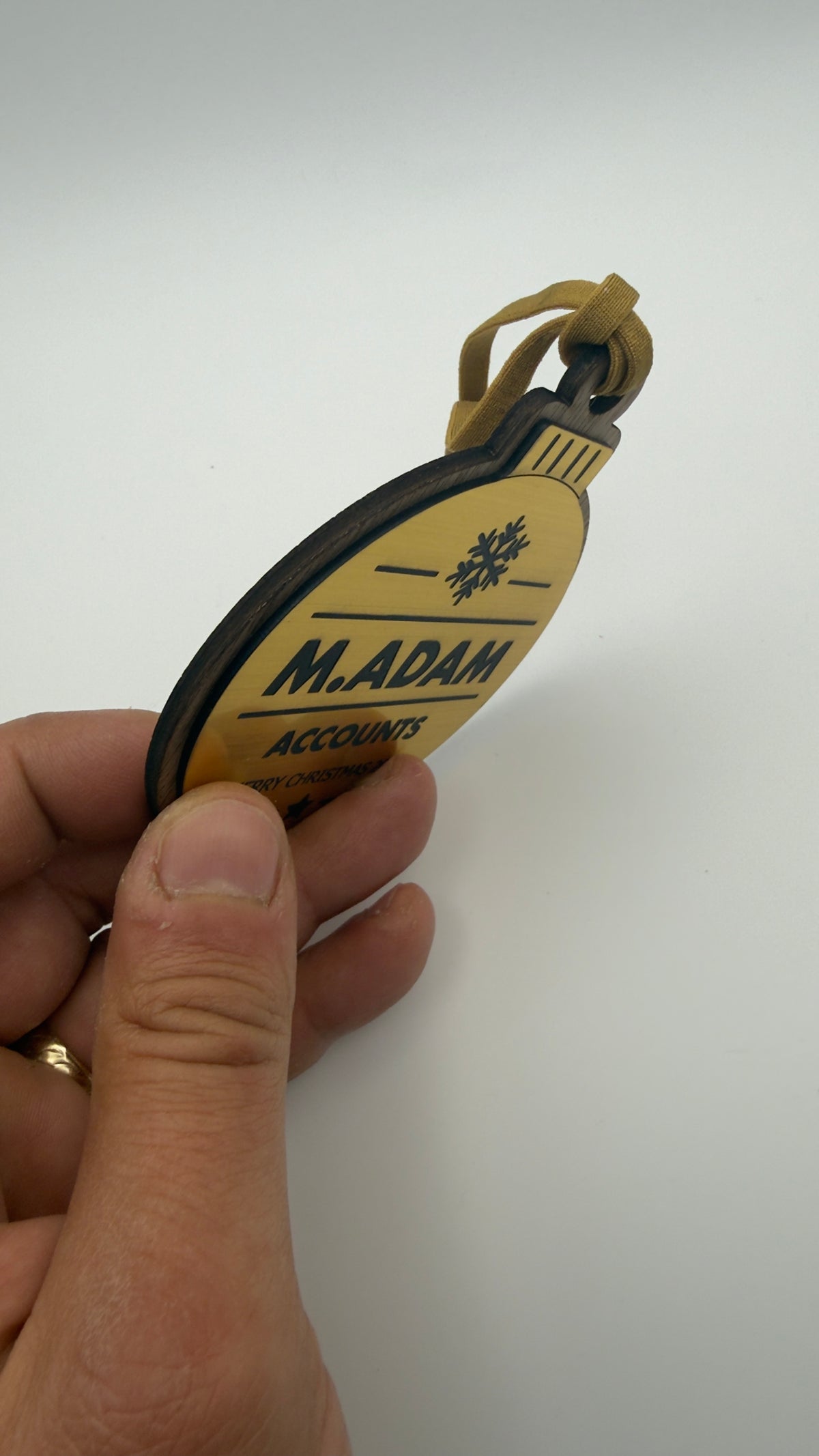 Gold personalised Christmas bauble Design 3, actual product photograph; standard design example, customer wording replaces example text. Hanging strip colour varies.