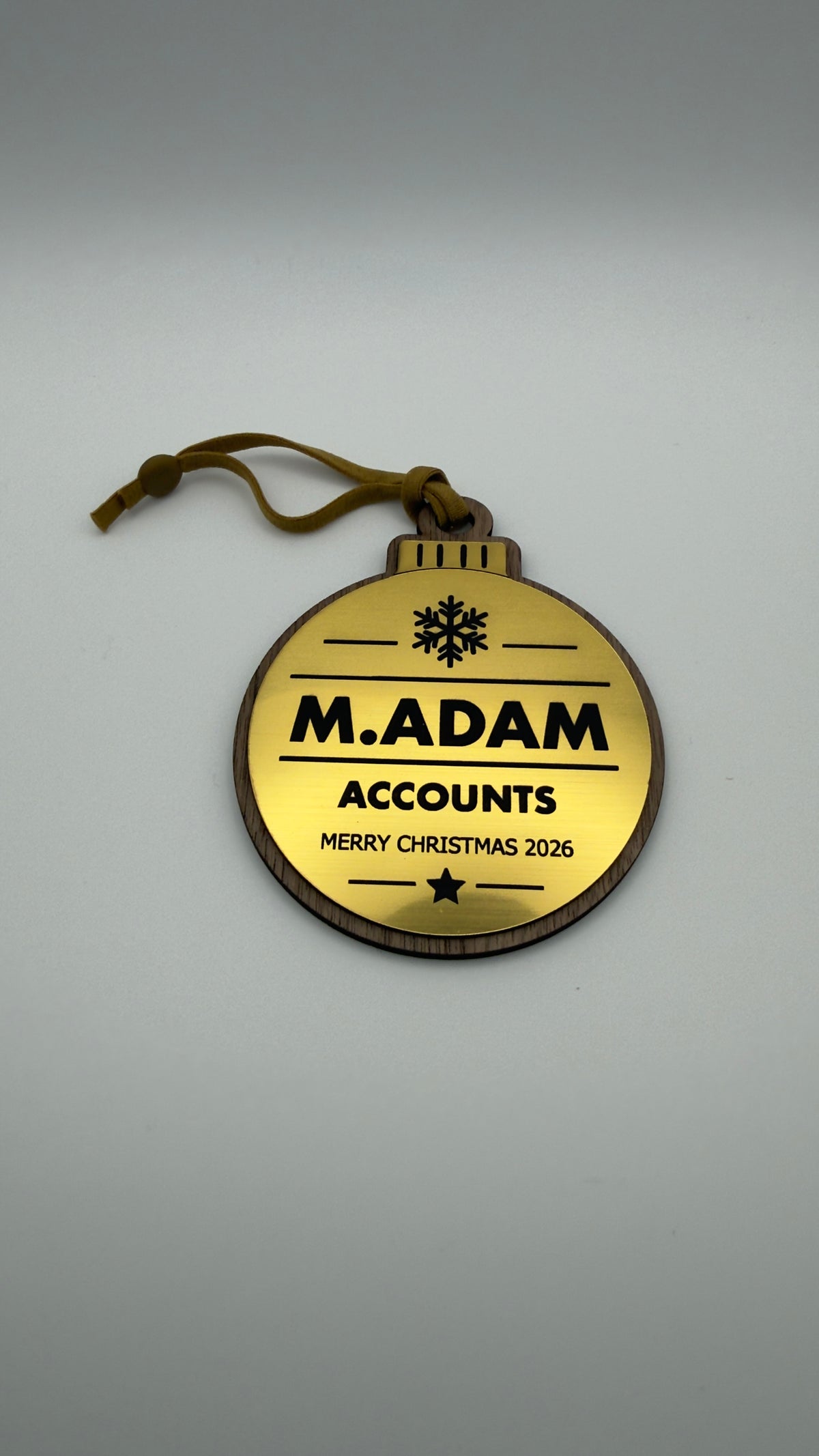 Gold personalised Christmas bauble Design 3, actual product photograph; standard design example, customer wording replaces example text. Hanging strip colour varies.