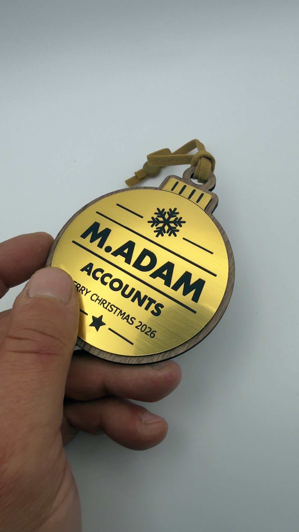 Gold personalised Christmas bauble Design 3, actual product photograph; standard design example, customer wording replaces example text. Hanging strip colour varies.