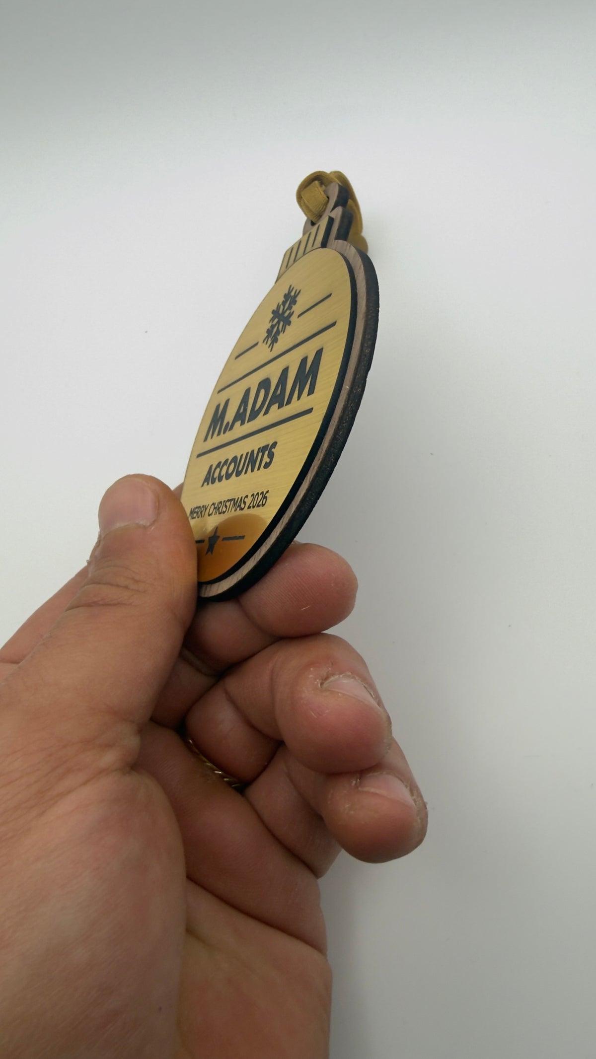 Gold personalised Christmas bauble Design 3, actual product photograph; standard design example, customer wording replaces example text. Hanging strip colour varies.