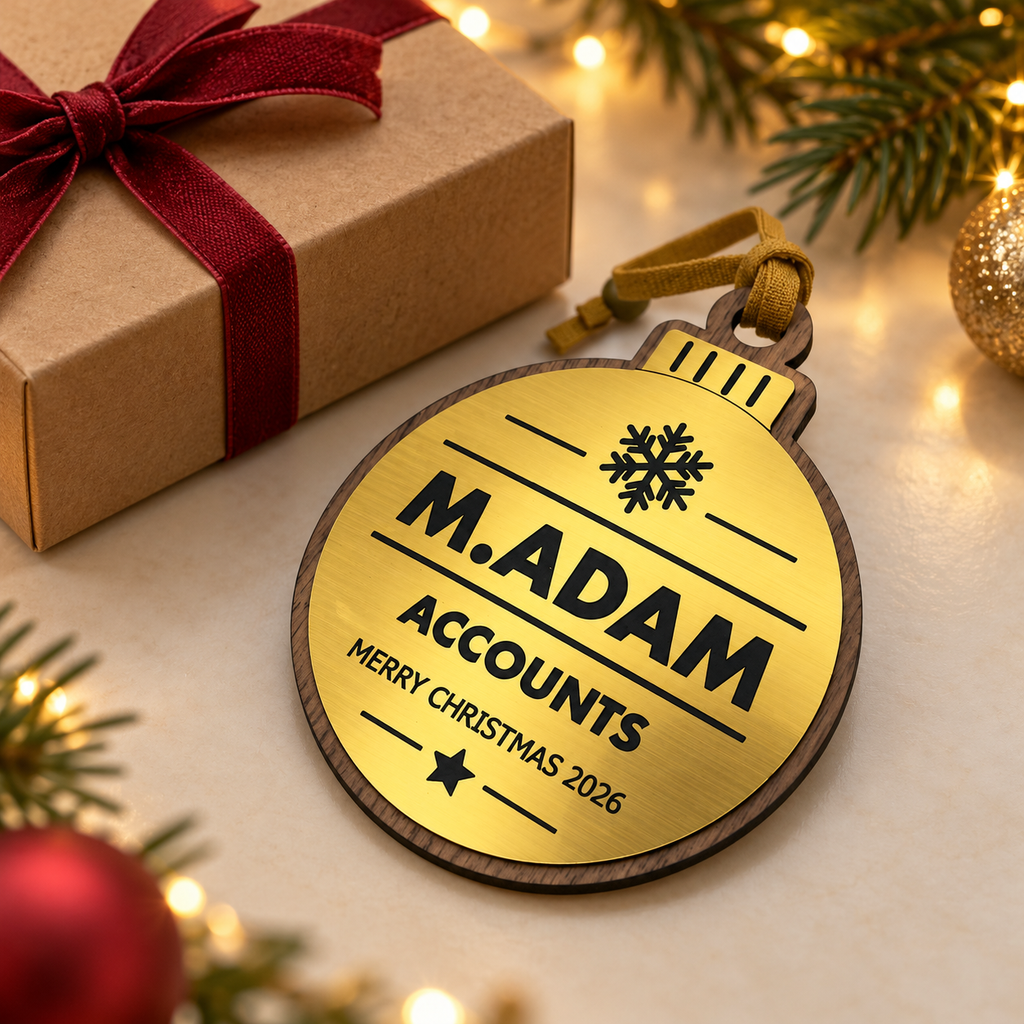 Gold personalised Christmas bauble Design 3, enhanced gift photograph; standard design example, customer wording replaces example text. Hanging strip colour varies, decorative props and gift boxes not included.