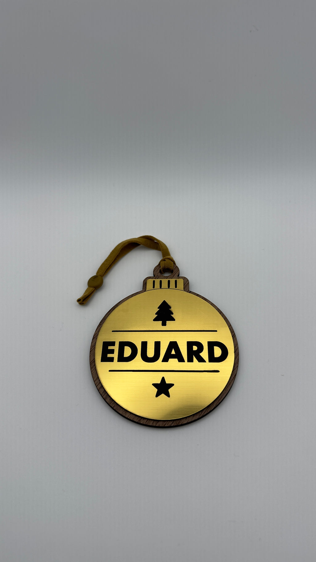 Gold personalised Christmas bauble Design 2, standard design example; customer wording replaces example text. Hanging strip colour varies.