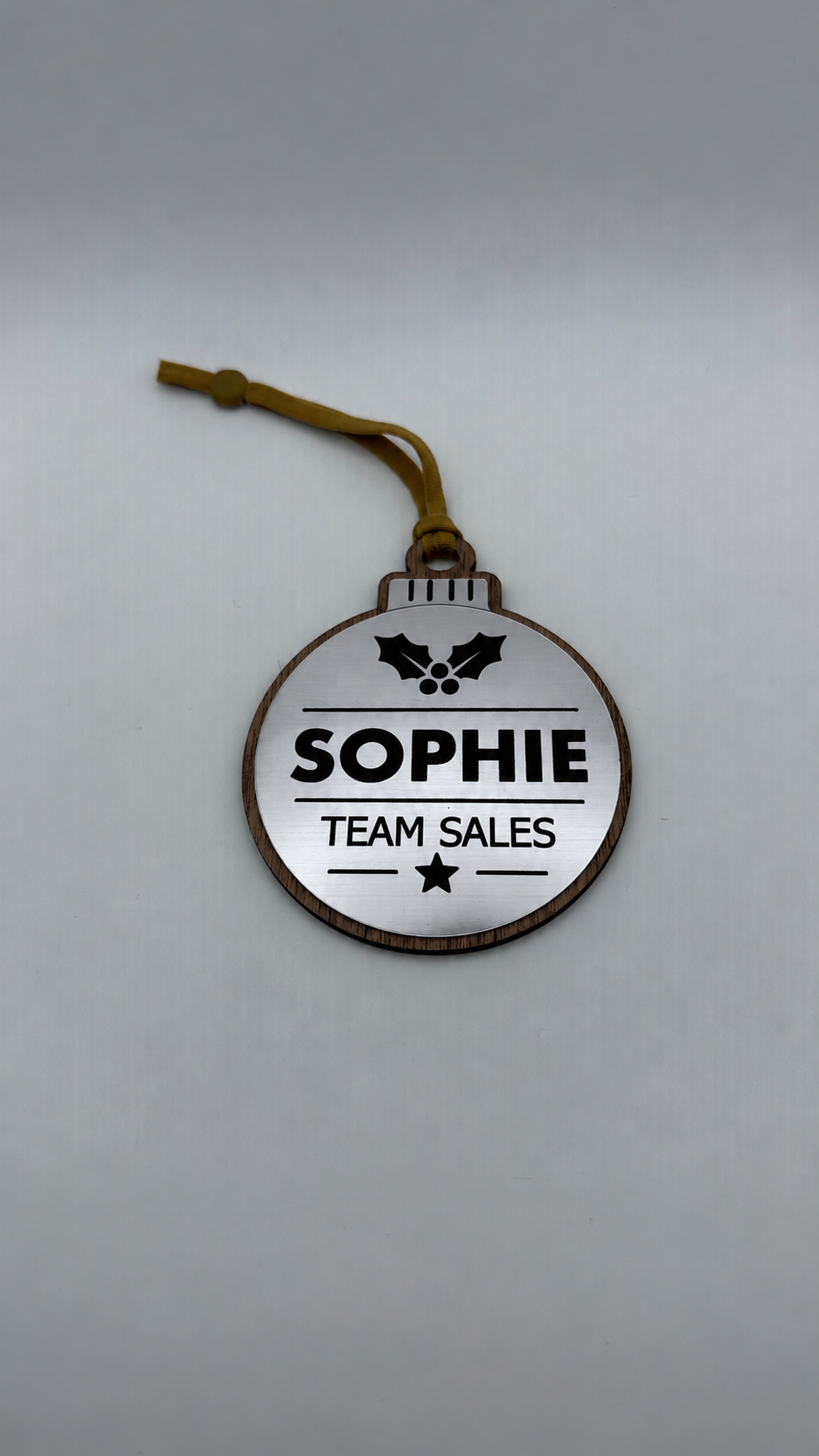 Silver personalised Christmas bauble Design 1, actual product photograph; standard design example, customer wording replaces example text. Hanging strip colour varies.