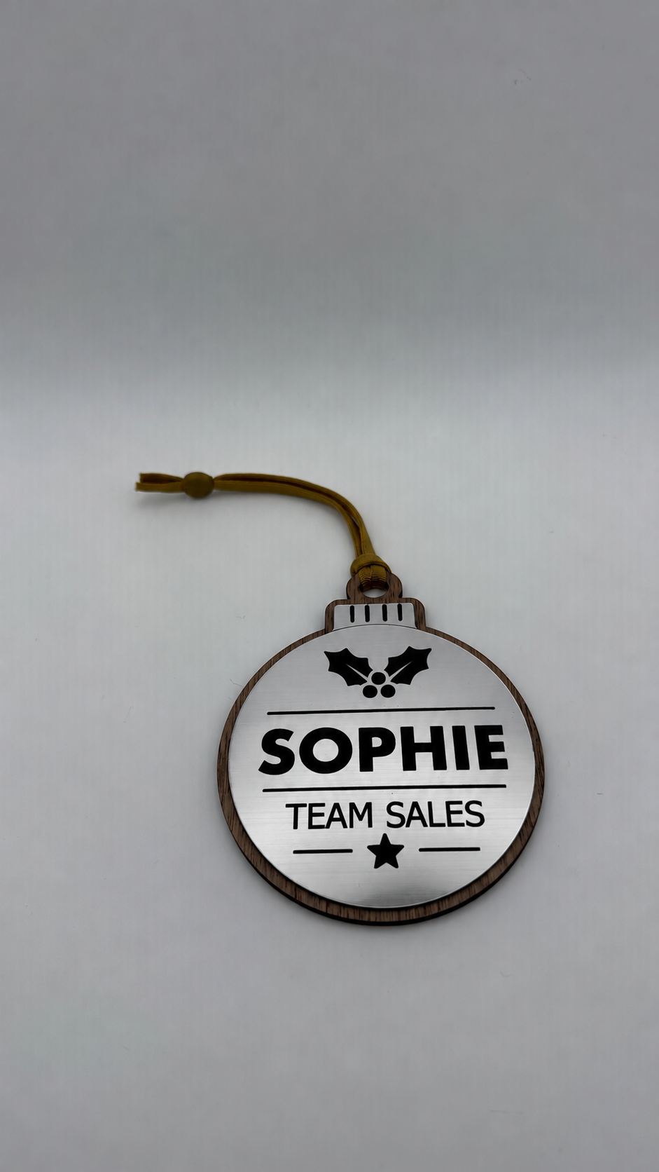 Silver personalised Christmas bauble Design 1, actual product photograph; standard design example, customer wording replaces example text. Hanging strip colour varies.