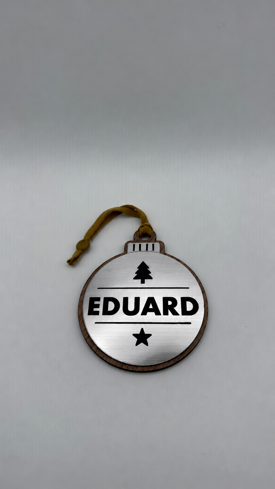 Silver personalised Christmas bauble Design 2, actual product photograph; standard design example, customer wording replaces example text. Hanging strip colour varies.