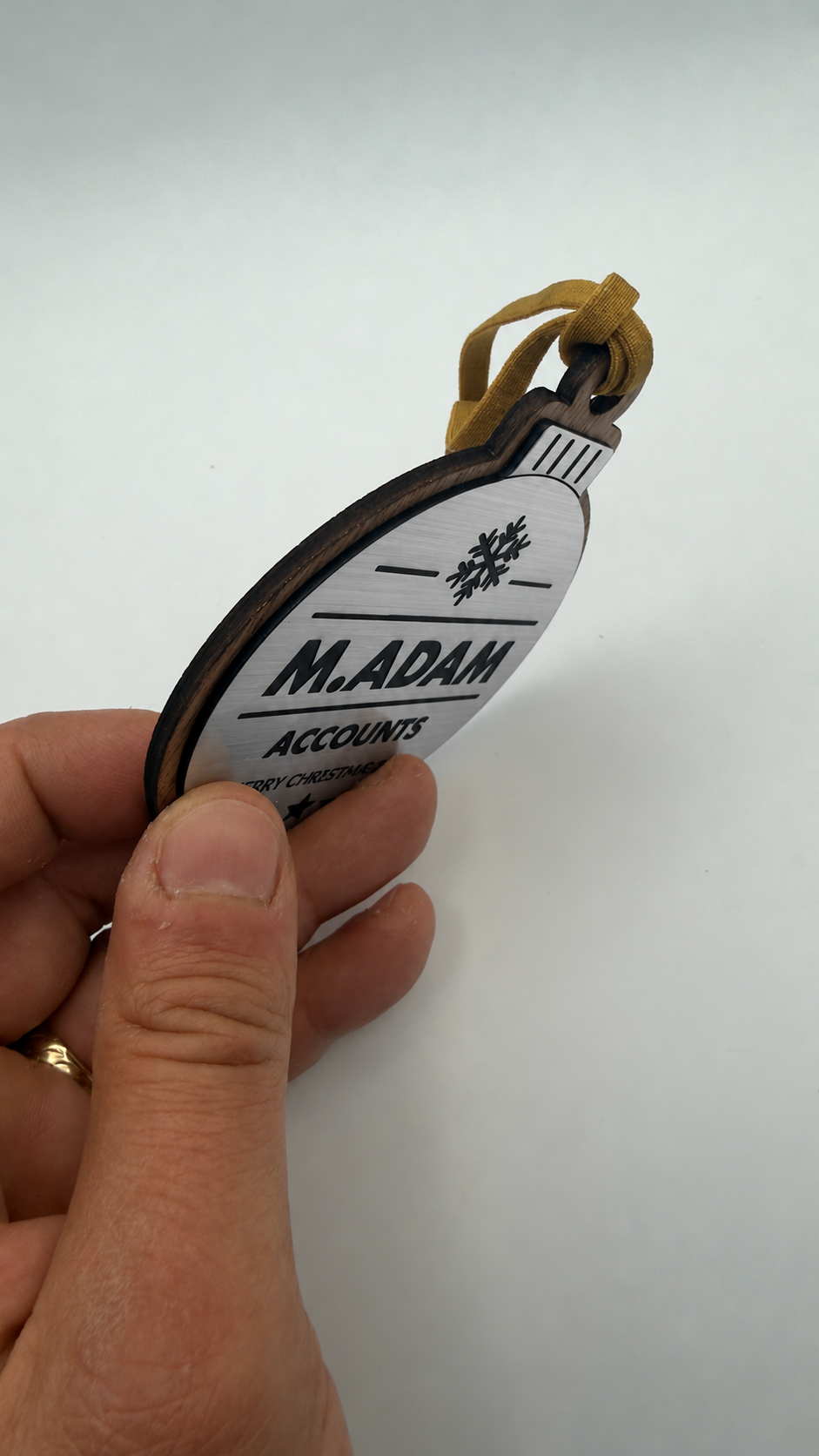 Silver personalised Christmas bauble Design 3, actual product photograph; standard design example, customer wording replaces example text. Hanging strip colour varies.