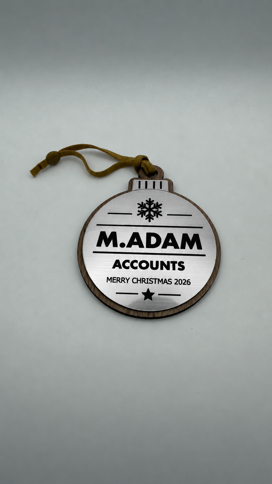Silver personalised Christmas bauble Design 3, actual product photograph; standard design example, customer wording replaces example text. Hanging strip colour varies.