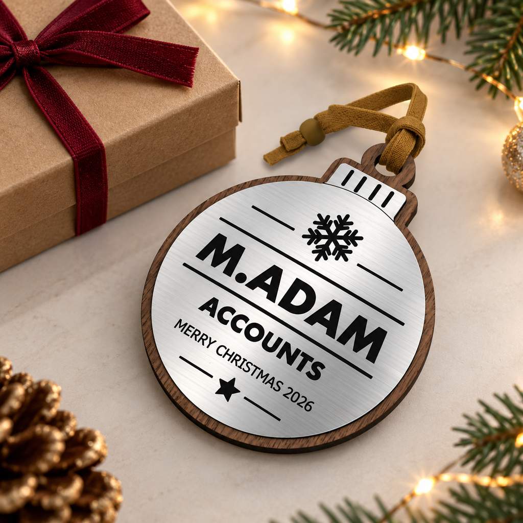 Silver personalised Christmas bauble Design 3, enhanced gift photograph; standard design example, customer wording replaces example text. Hanging strip colour varies, decorative props and gift boxes not included.